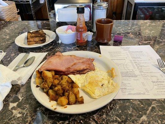 Two eggs over easy, home fries, three slices of ham, raisin toast and coffee. Good food, great service will be back again.