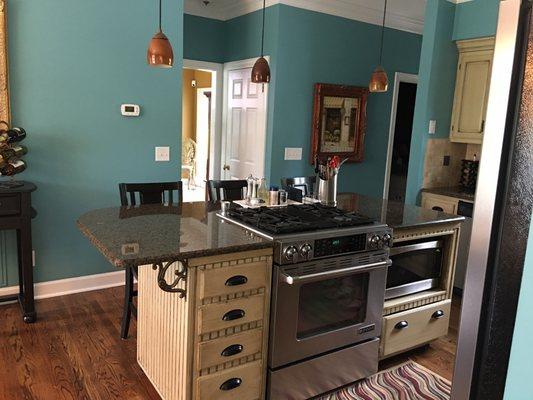 Glazed cabinets with teal wall color