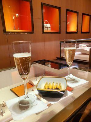 Sipping on Veuve and indulgiing in delicious chocolates while waiting for the purchase to be completed