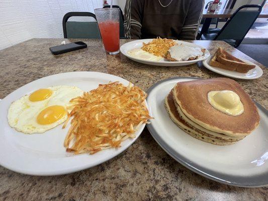 3 stack of fluffy buttermilk pancakes with a side of hash browns and sunny side up eggs. DELICIOUS.