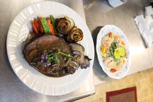 Absolutely delicious prime rib with bacon potato roses, carrots, peas and shrimp alfredo!