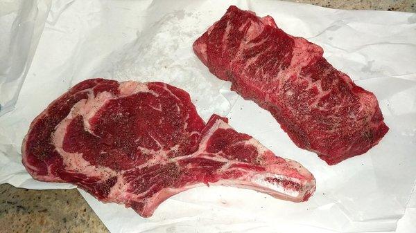 Seasoned ribeye and a piece of brisket.