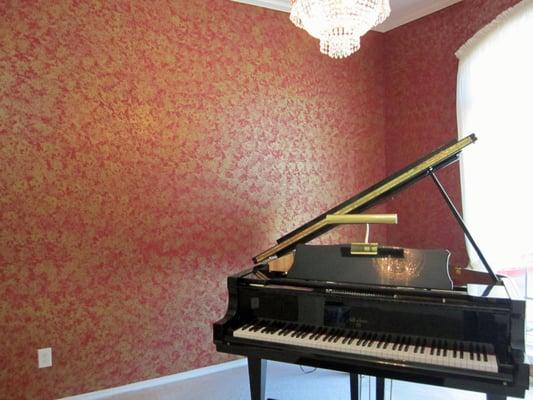 The red and gold faux finish in this music room creates a breathtaking effect.