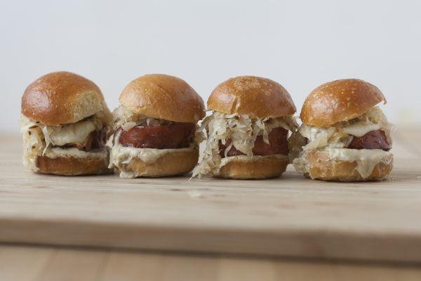 Kielbasy sliders served with kraut, grilled kielbasy, bryndza cheese and housemade mustard sauce