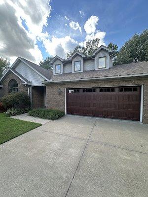 Stunning wood look garage door with windows.