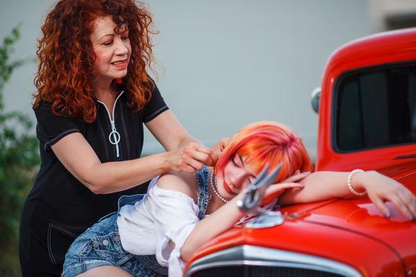 The hairstylist making sure she's on point for the photo.