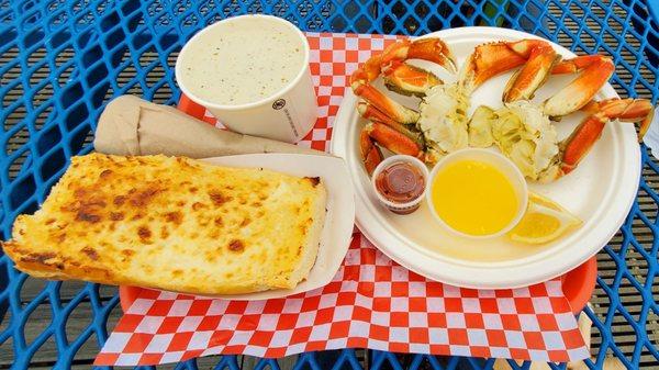 Whole crab, bowl of clam chowder, cheesy bread