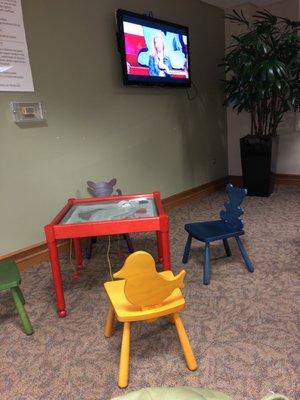 Kids area and TV for waiting guests.