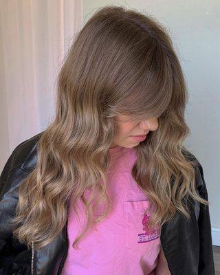 "Here's what we did..

Full custom color using teasy lights and tip-outs, root shadow, global gloss, haircut and a long curtain bang"