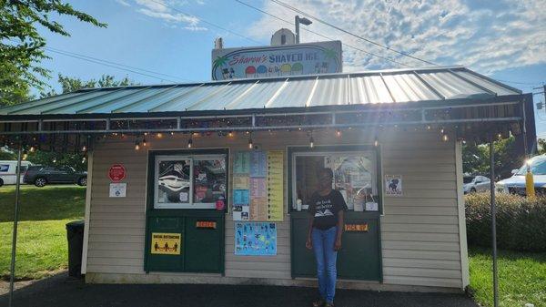 My daughter photo bombing my picture of the snowball stand! Lol