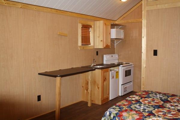 Full Kitchenette with full range stove,oven,microwave, refrigerator, cabinets,sink and dinning table.