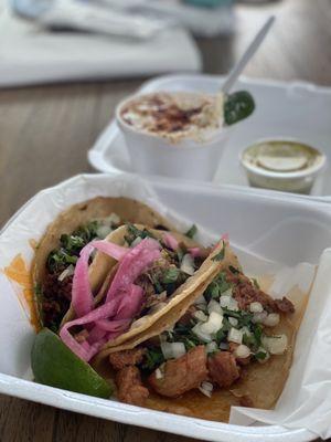 From right to left, all tacos, Al Pastor, Carnitas with pickled onions, and chorizo. Elite/Corn in a cup in the back.