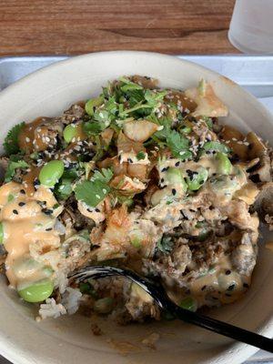 Bulgogi bowl with kimchi, edamame, cilantro, jasmine rice, and 1/2 siracha aioli and 1/2 peanut sauce (recommended by the employee)