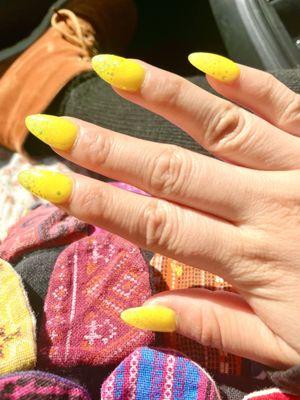 top down view of neon yellow acrylic nails