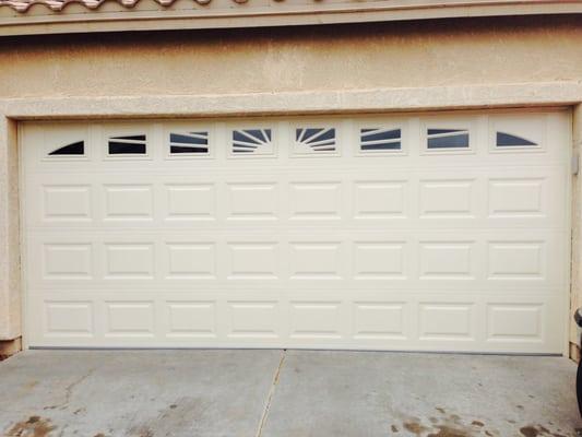 Short panel garage door with a sunburst window pattern