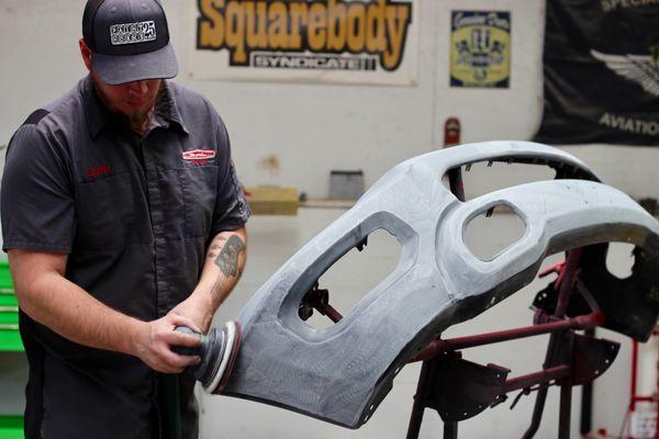 Our painter prepping a bumper for paint.