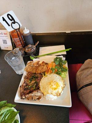 Grilled pork chop with grilled shrimp.  Along with omelet egg on top of jasmine rice.