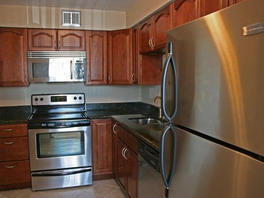 Upgraded kitchens include all stainless steel appliances, wood cabinets and granite counter tops.