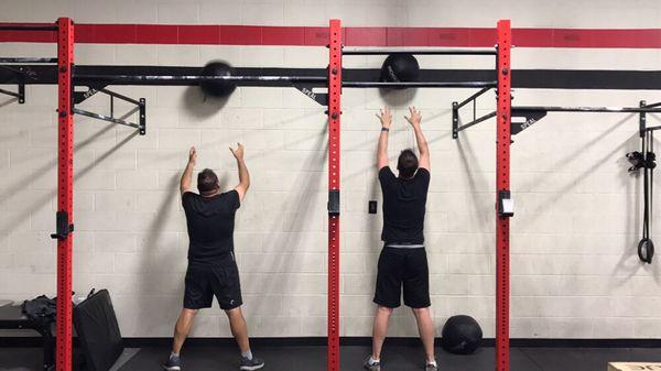 Wall Ball action. Glutes/Quads, core, cardio and delts.