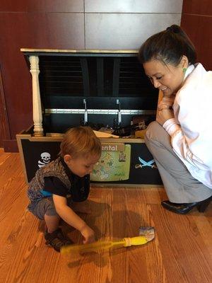 Our little boy with good Dr. Tsang, selecting a toy from the treasure chest after his first dental appointment!!