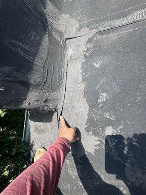 Identifying a crack on the roof. Taurus Roofing & Siding specializes in precise inspections and quality repairs.