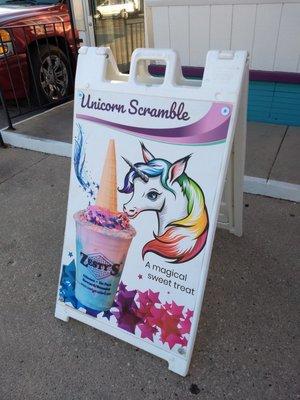 Unicorn Scramble=blue moon ice cream with cotton candy, sprinkles, and topped with an ice cream cone...my gut it hurts thinking about it