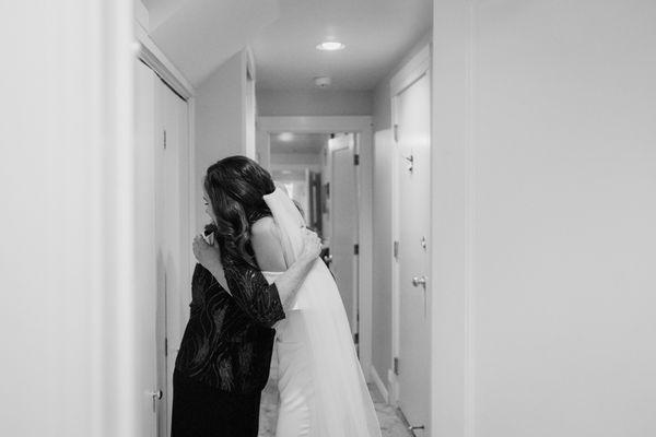 Capturing special moments, like a hug between bride and mother of the bride