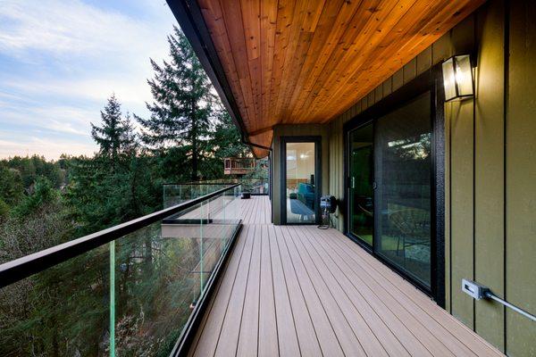 Deck and glass railing. Cedar soffits