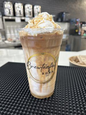 Iced Caramel Latte with Whipped cream and Caramel syrup on top