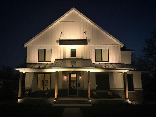 Illuminated home with LED landscape lighting for both first and second stories.