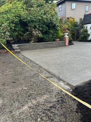 Driveway concrete and small retaining wall