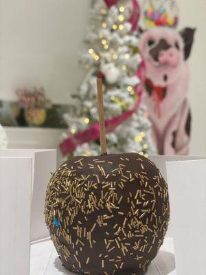 Gold sprinkled chocolate and caramel covered apple.