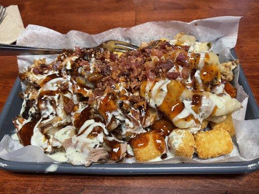 Pig Taters - tater tots with pulled pork and pepper Jack cheese with spicy sauce. Best I've ever had.