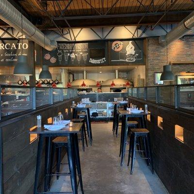 Interior: High top table alley at edge of bar area with view of twin pizza ovens. The location is Southbury, not Danbury (?)