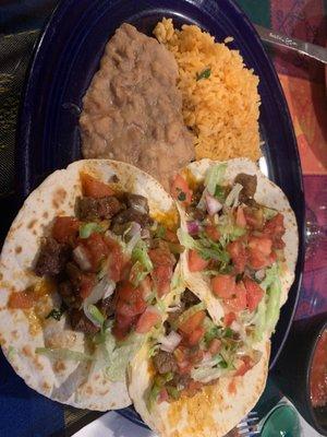 Steak tacos w/ refrieds and rice.