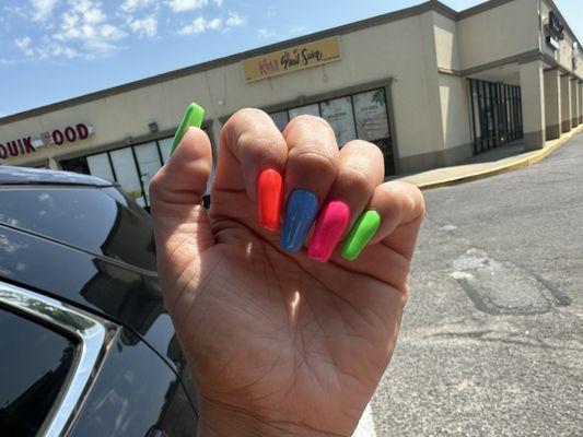 Nail salon in background.