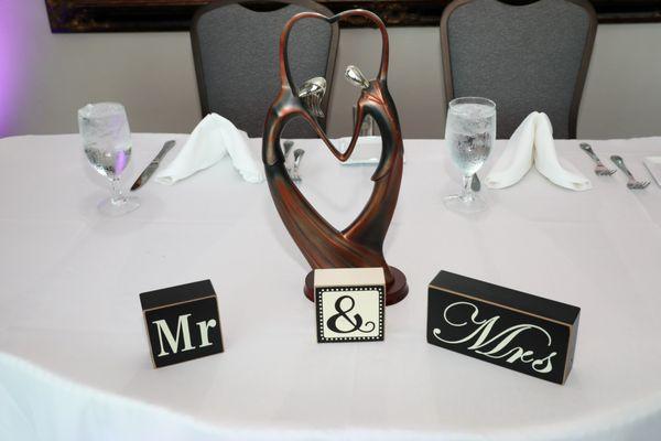 Allan even help make the bride and groom table feel extra special with decor