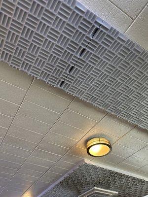 Acoustic tiles along the ceiling. Nice attention to detail.