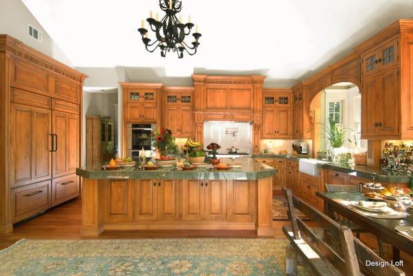 This traditional kitchen exhibits classical design using honey-glazed Maple cabinetry, marble backsplash and granite countertops