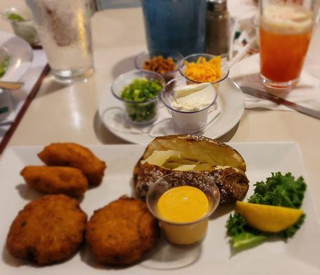 Crab cakes and potatoe with the fixings