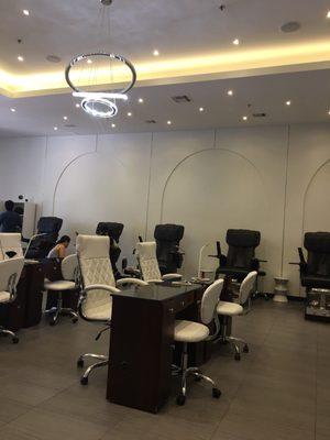 Ample Pedicure chairs on both sides of the salon.