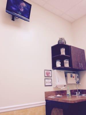 Televisions in exam rooms to keep kiddos entertained.