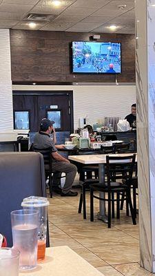 Staff, including our waitress, having a lunch break while we are waiting for the check.