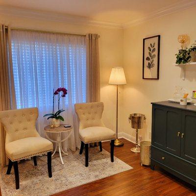 Cozy waiting area offering water and tea.