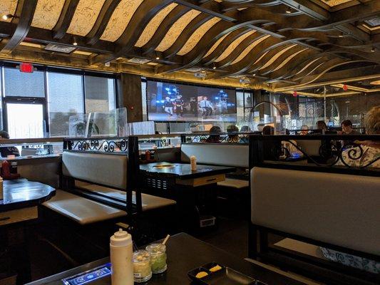 Inside. Dining room. Facing storefront windows looking into the parking lot. They have a big screen playing K-pop music videos.