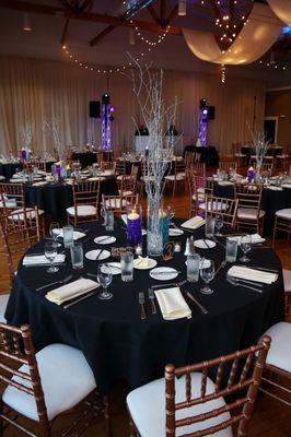 Centerpieces silver branches, vases with waterbeads and floating candles.