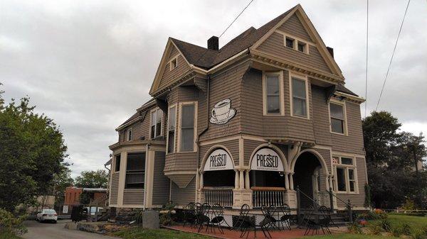 Nothing cookie cutter here.  This bohemian AF Victorian makes for a great coffeehouse.  In the foreground is the drive to their parking lot.