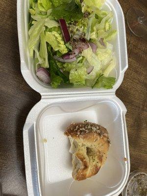 Side salad with Italian dressing and garlic roll