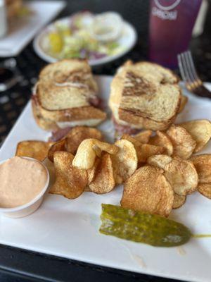 Rueben sandwich with chips and Greek Salad