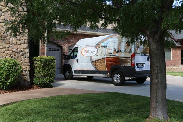 White N-Hance Wood Refinishing van outside of home